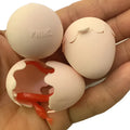 Fake snake egg prank toy with plastic egg shell and stretchable snake on plain background