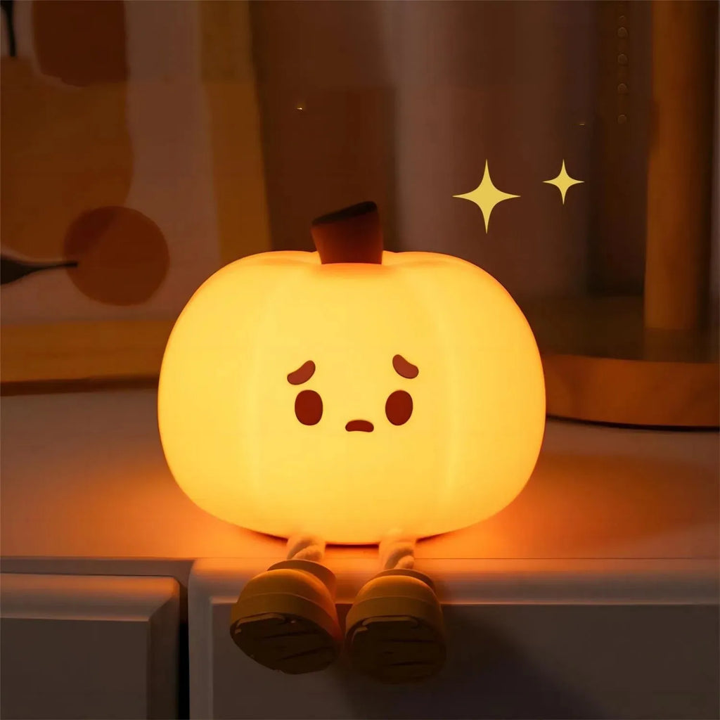 Orange pumpkin-shaped silicone night light with soft glowing illumination