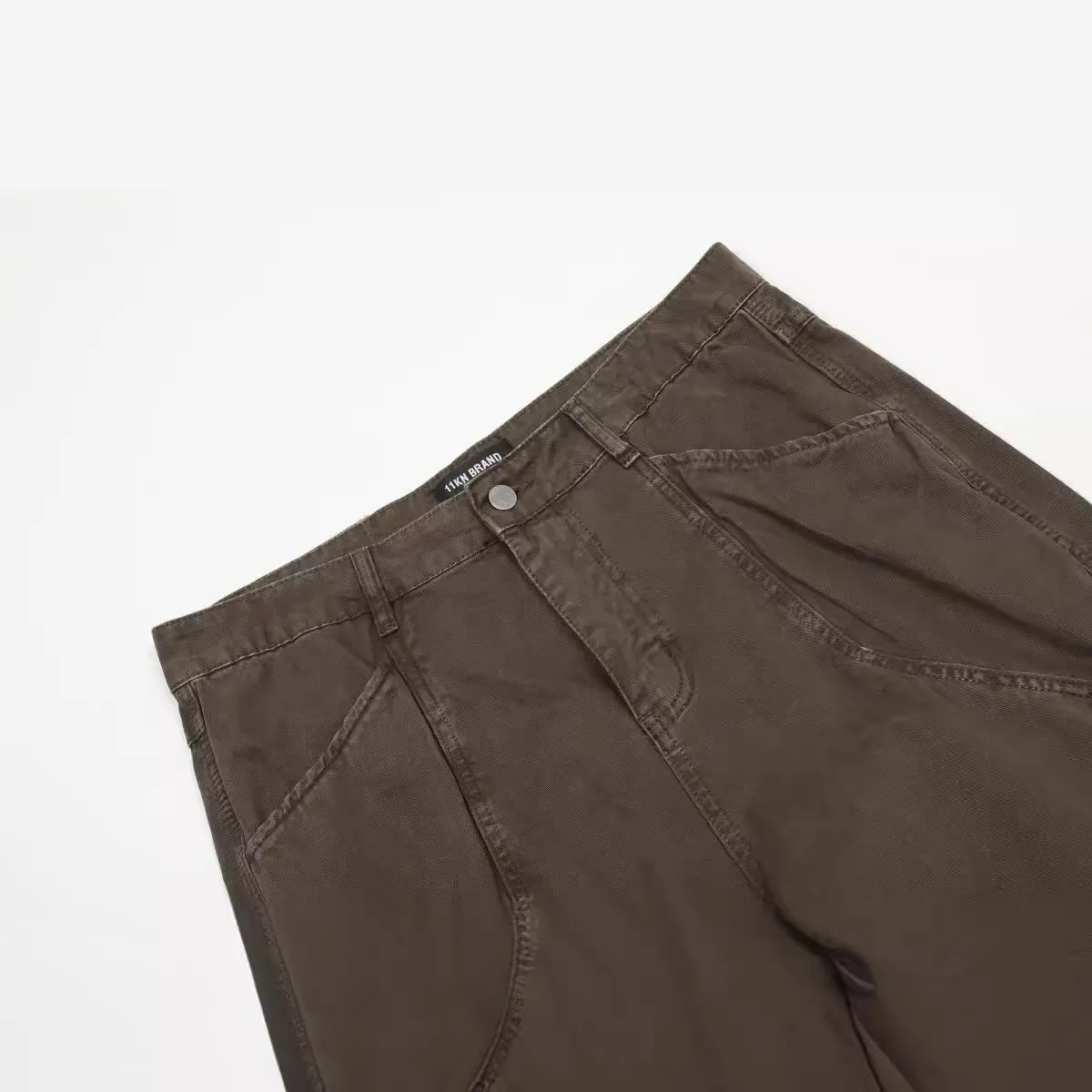 Men's brown loose straight leg jeans with high waist design and zip fly closure