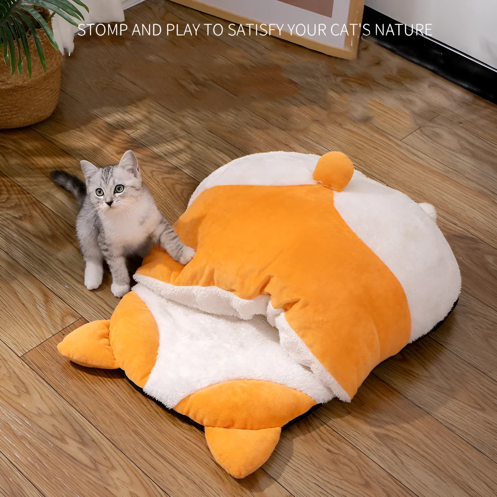 Orange semi-enclosed cat sleeping bag bed on a floor, showing its nest shape and dimensions.