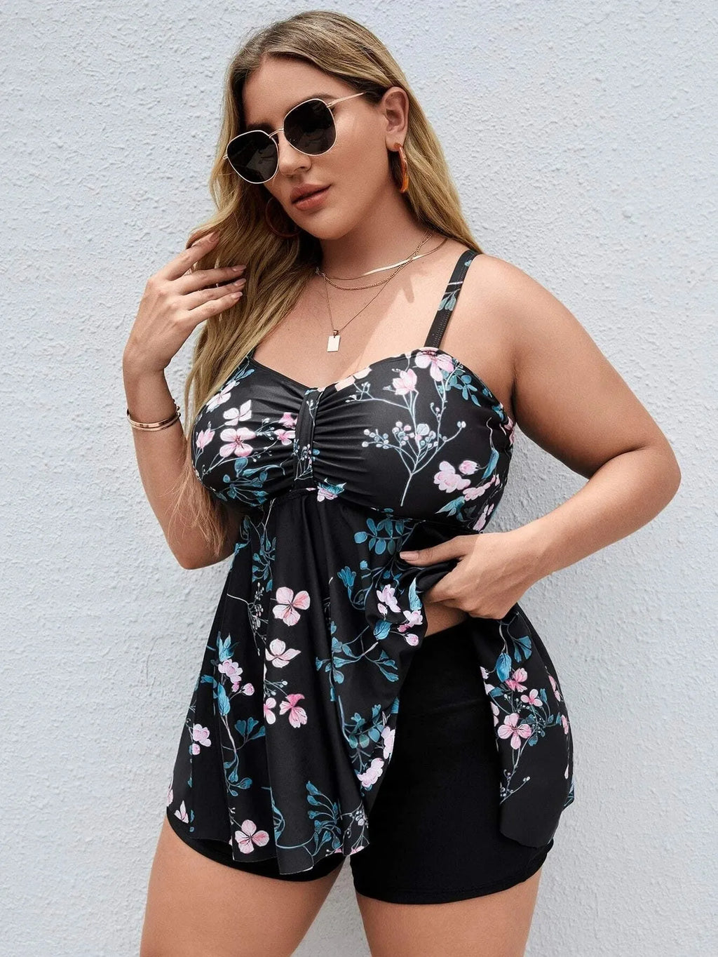 Women's floral print one-piece swimsuit on hanger, showing split colour design and high-elasticity polyester fabric.