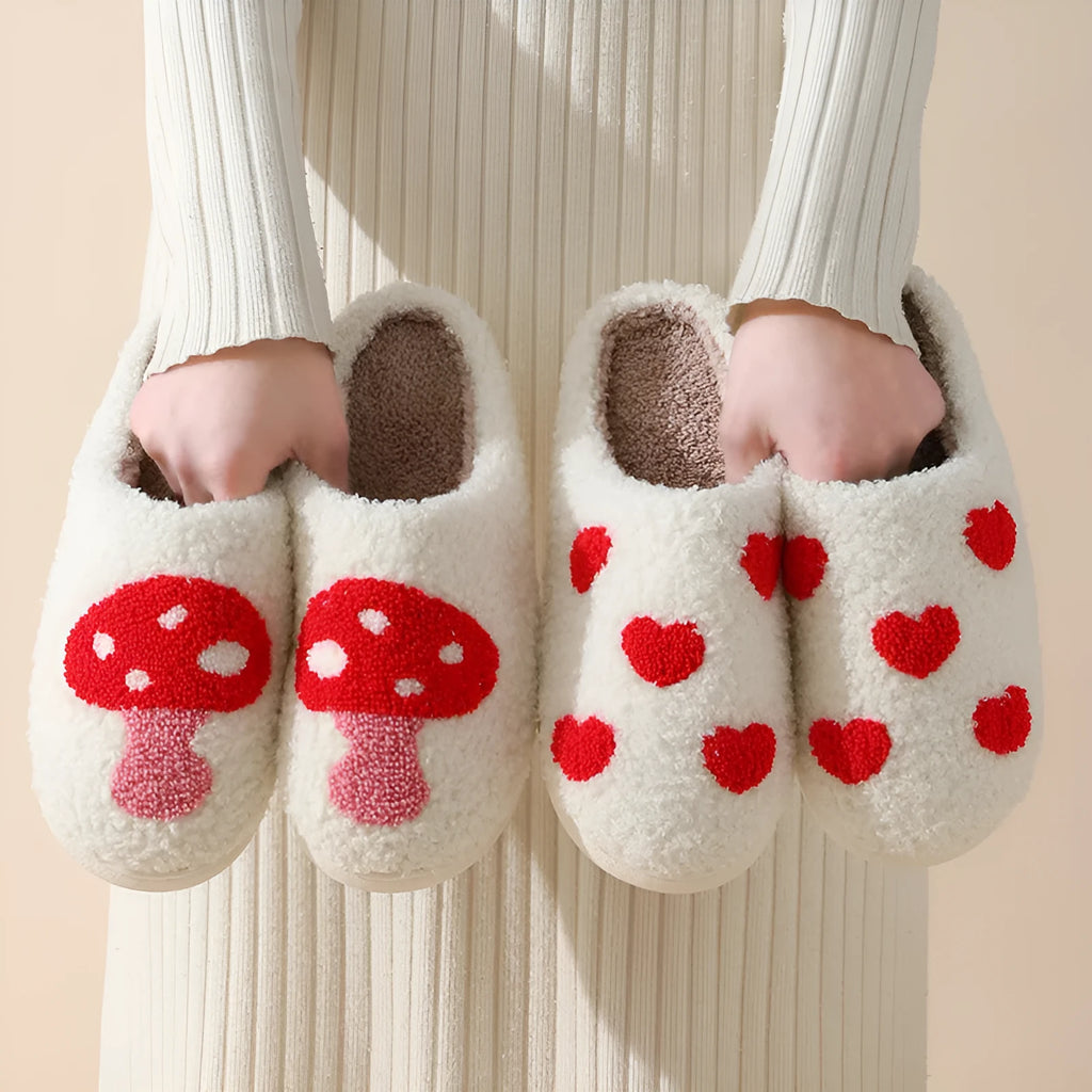 Women's plush slippers with cartoon love design, showing round toe and non-slip PVC sole.
