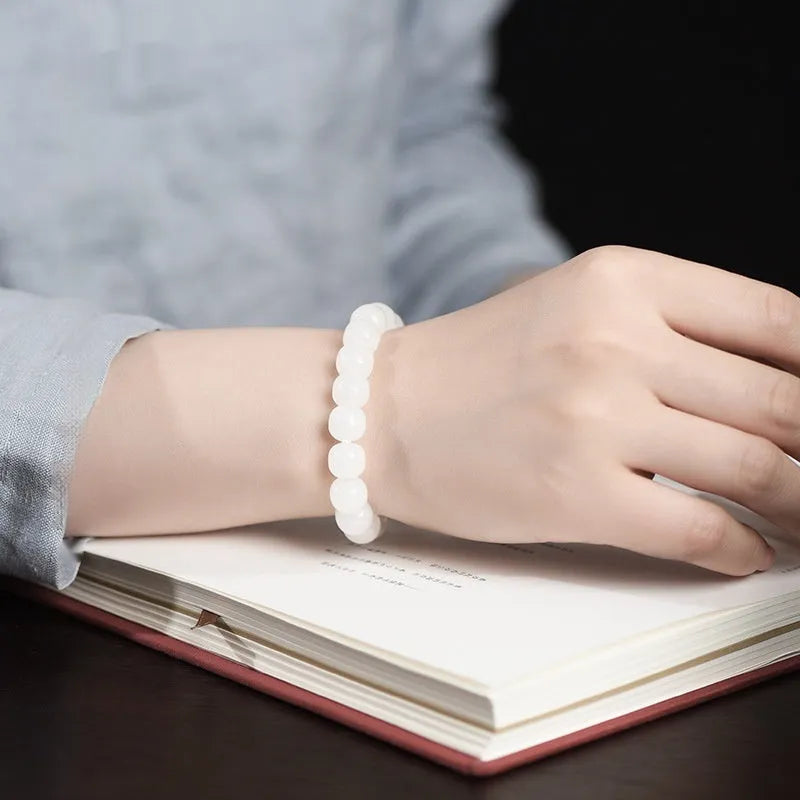 White Hetian jade barrel bead bracelet for men and women showing polished beads.