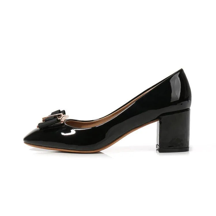 Mid heel round toe chunky heel pumps in solid colour with work buckle detail on a white background