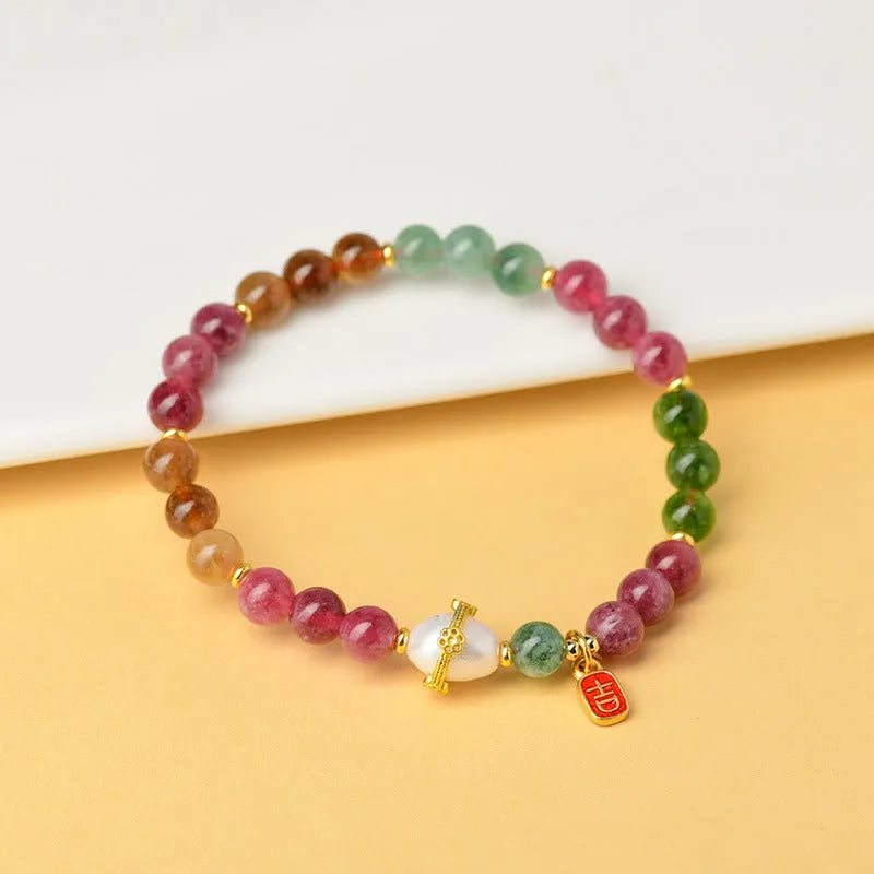Geometric chalcedony crystal bracelet with 6.5mm beads on a wrist.