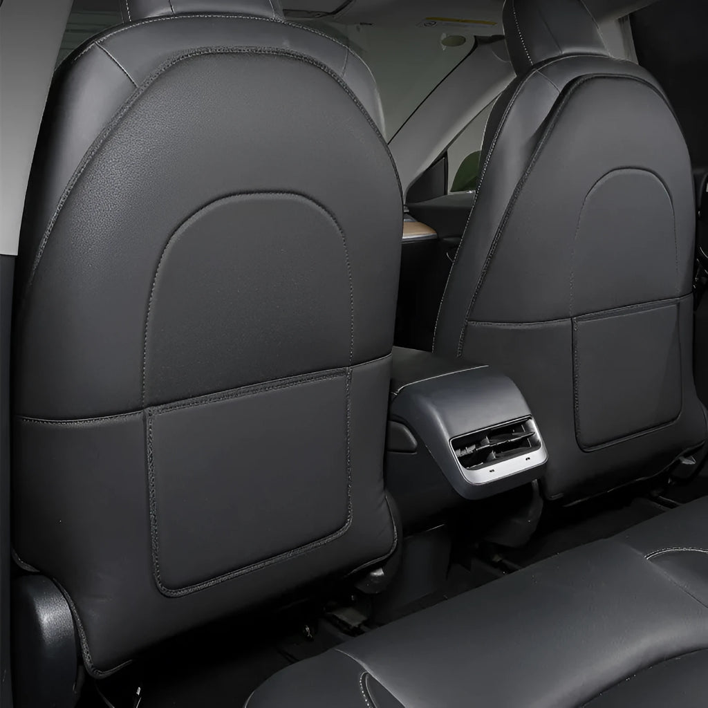 Two black leather rear seat anti kick pads measuring 68cm by 42cm for car seat back protection