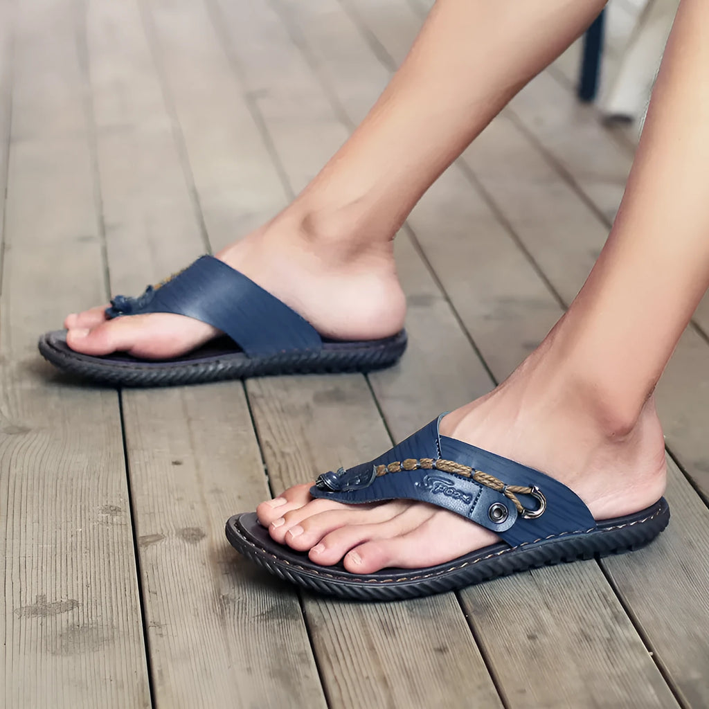 Men's black casual slippers with a non-slip sole and PU leather upper on a plain background.
