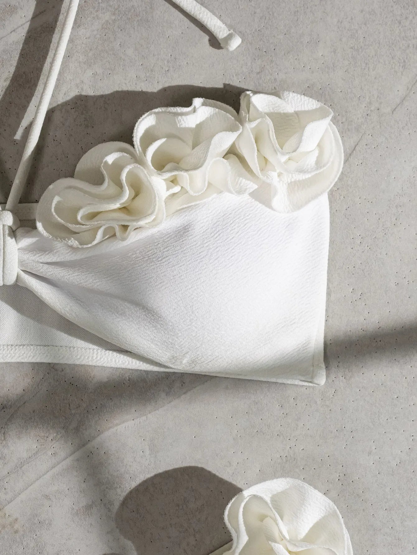 White halter neck lace-up swimsuit with three-dimensional floral details and brief bottom