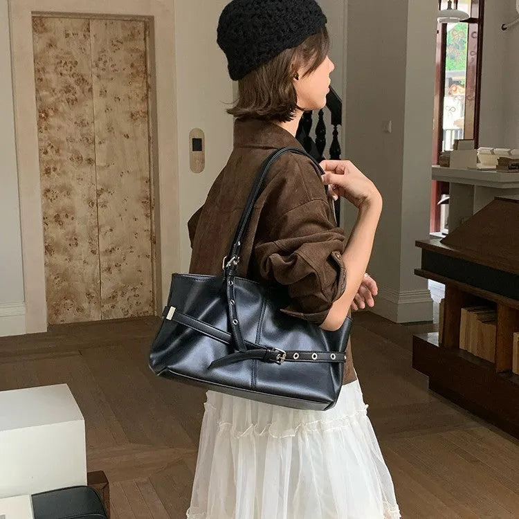Women's large capacity PU shoulder bag in black with visible sewing line detail and horizontal square shape