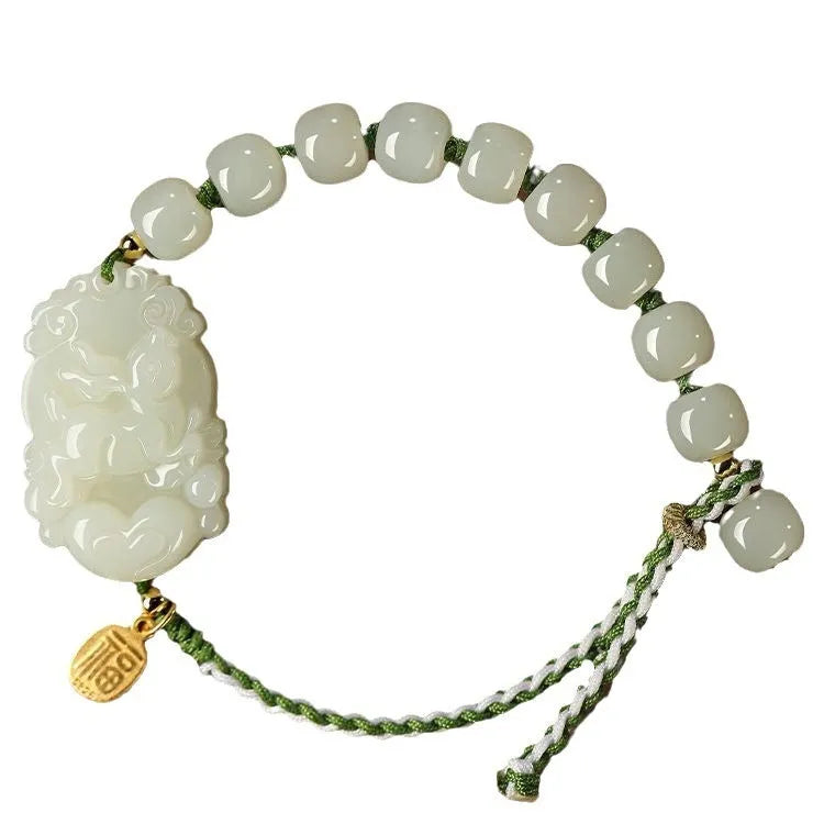 Year of the Rabbit Hetian jade charm bracelet with S925 silver detailing on a red cotton rope.
