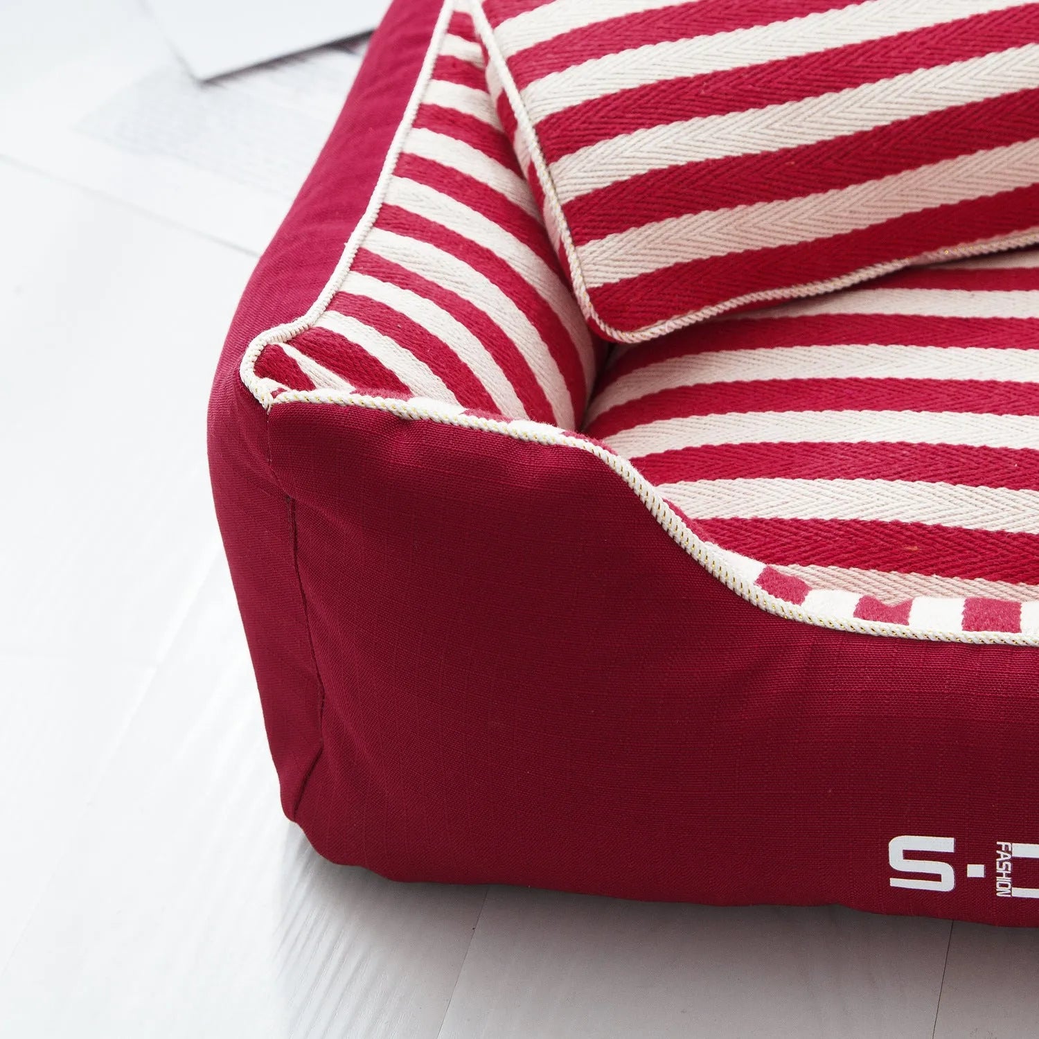 Navy striped washable dog kennel mat with removable cover and a red mini pillow.