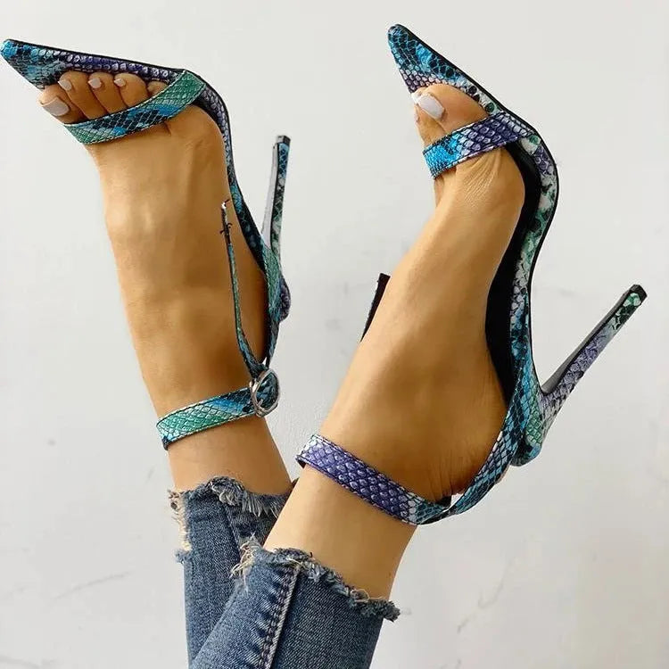Blue women's high heels with buckle fastening and hollow out design on a pointed toe.