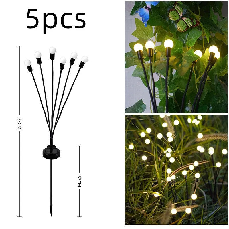 Solar-powered LED pneumatic firefly ground stake light with multiple heads on a grassy lawn.