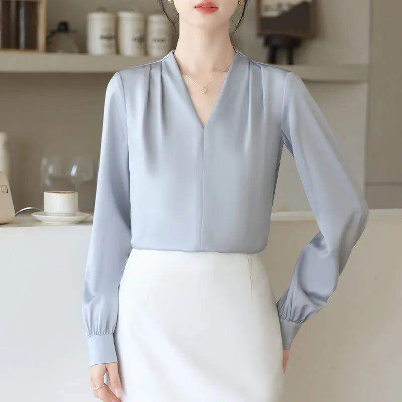 Blue slim fit long sleeve women's satin shirt with 3D stitching on a hanger.