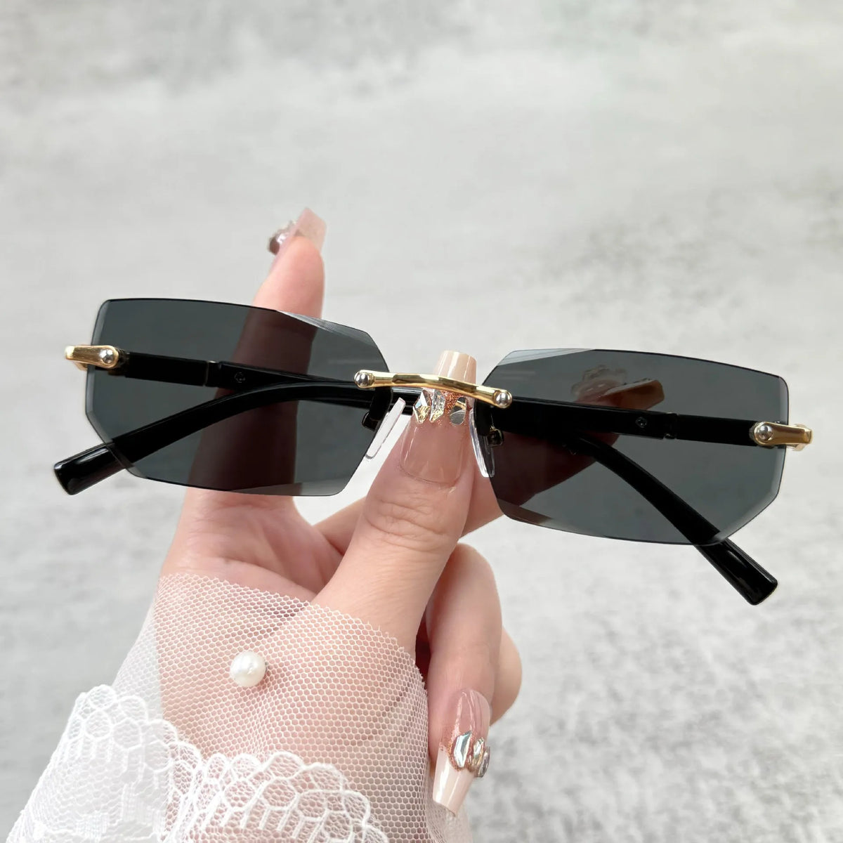 Unisex frameless water drop sunglasses in black, transparent, gold and gradient grey for sun protection and outdoor wear