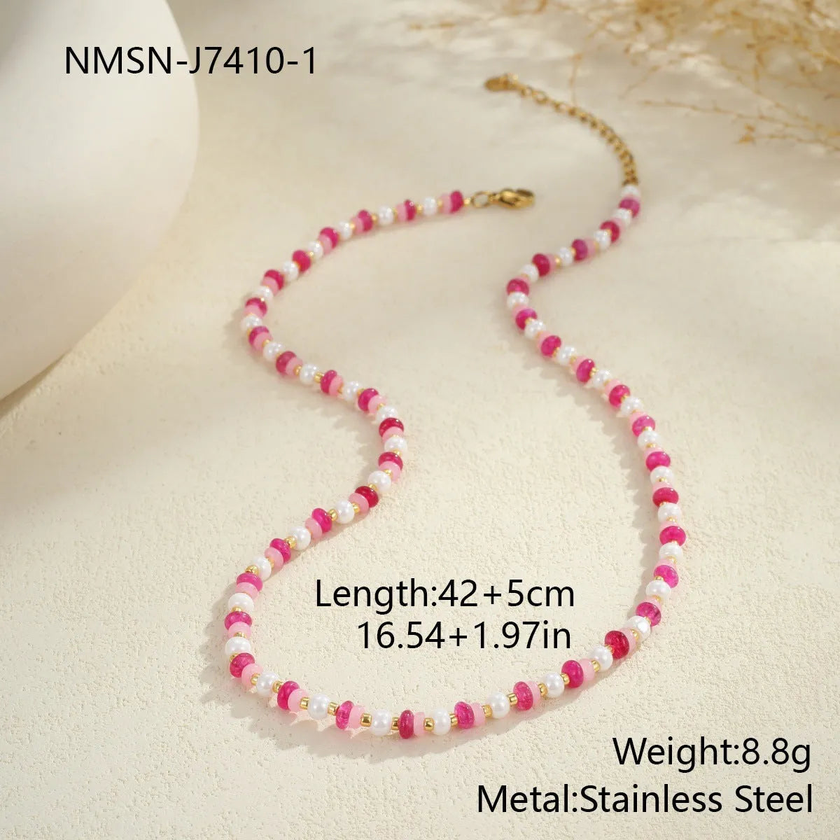 Sweet resin beaded necklace with geometric 18K stainless steel pendant, pink beads, and regular chain on light background