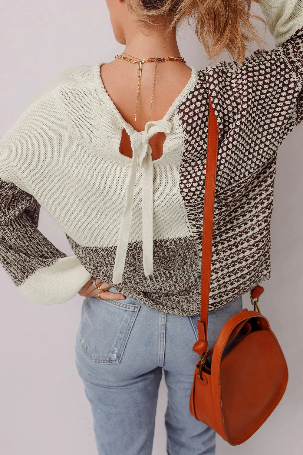 Dark khaki colour block women's loose knit sweater with a back tie and drop shoulders.