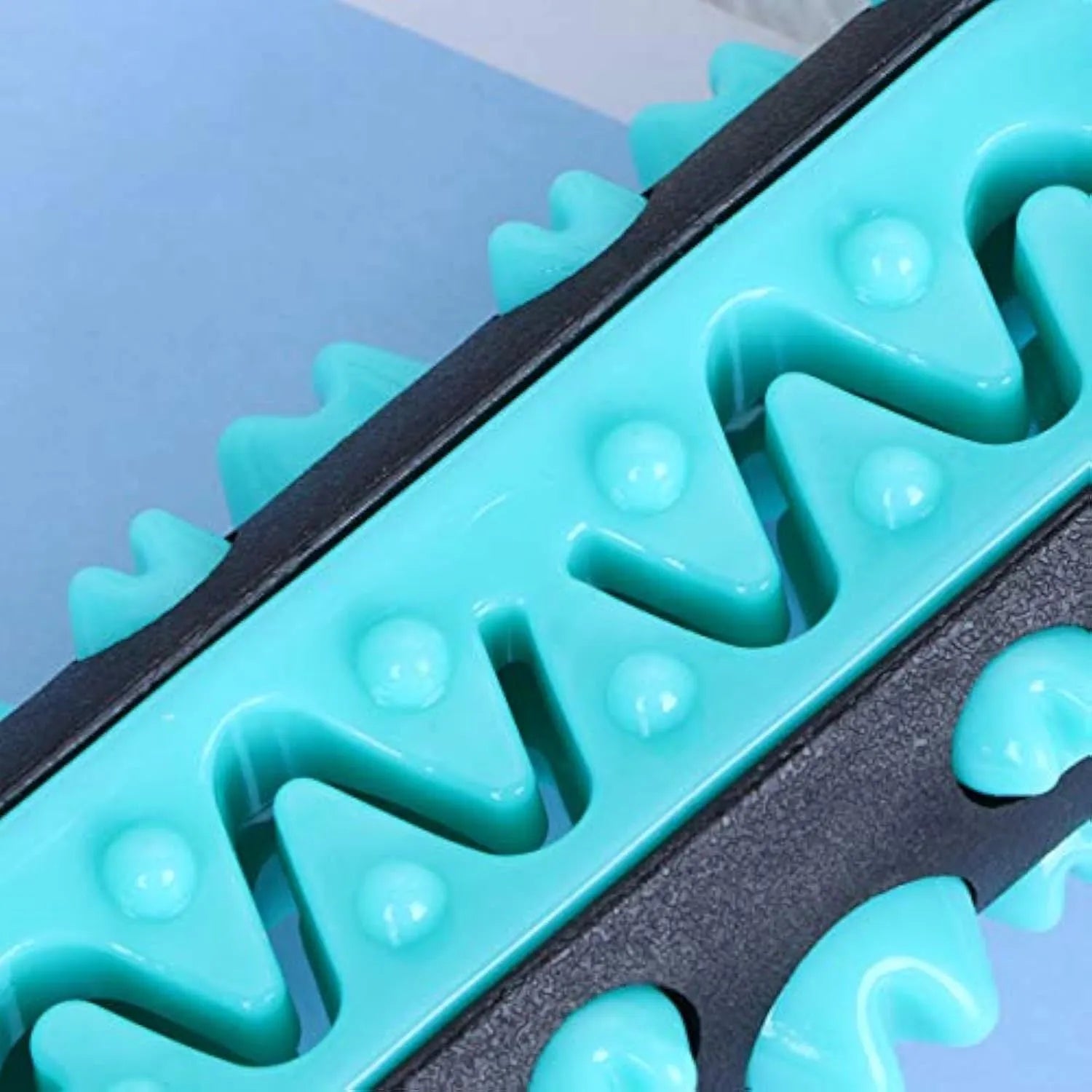 Natural rubber dog toothbrush chew toy with textured bristle surface in blue colour