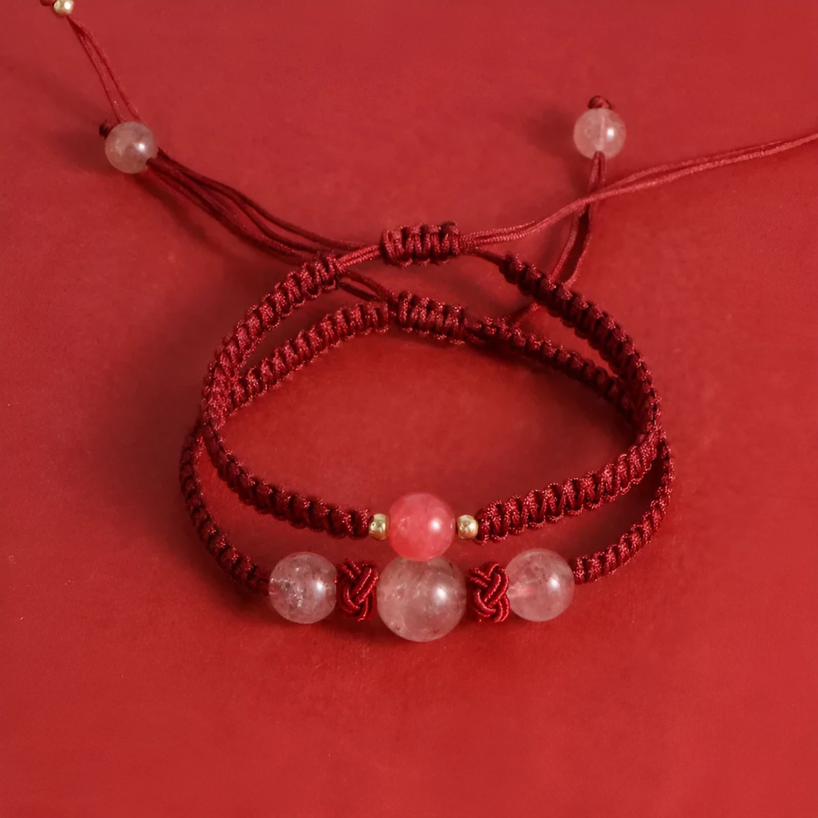 Natural strawberry quartz beaded bracelet on woven red rope with alloy clasp