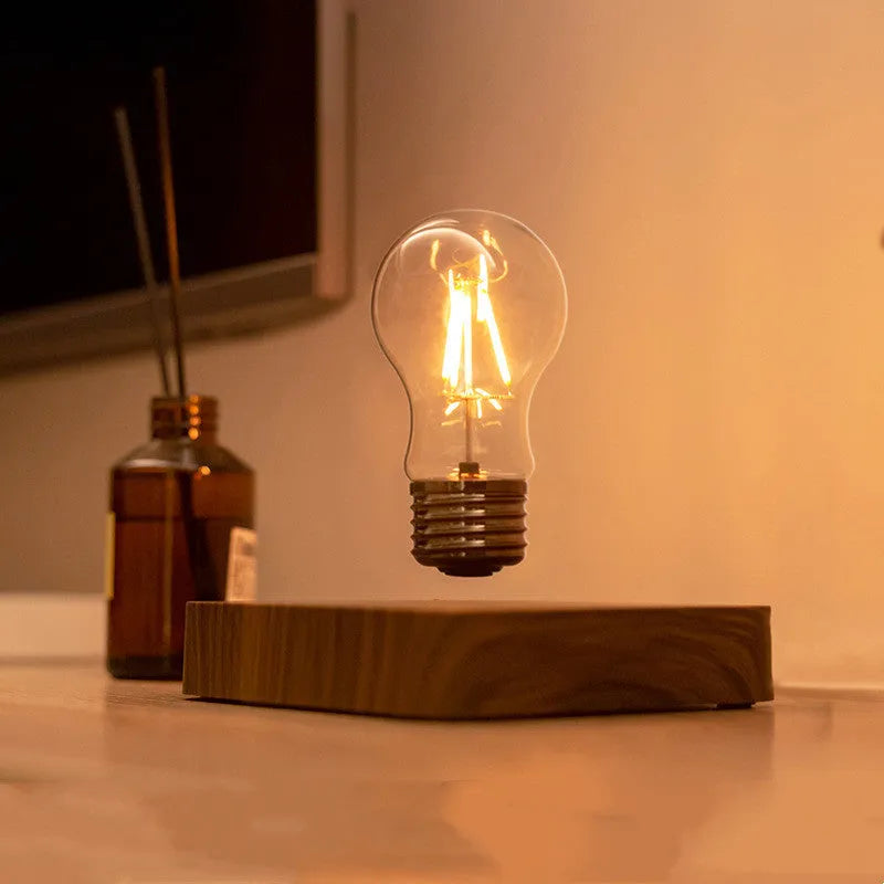 Self-rotating maglev bulb with warm yellow light, ABS base, 6cm diameter bulb, and 13.5cm diameter base.