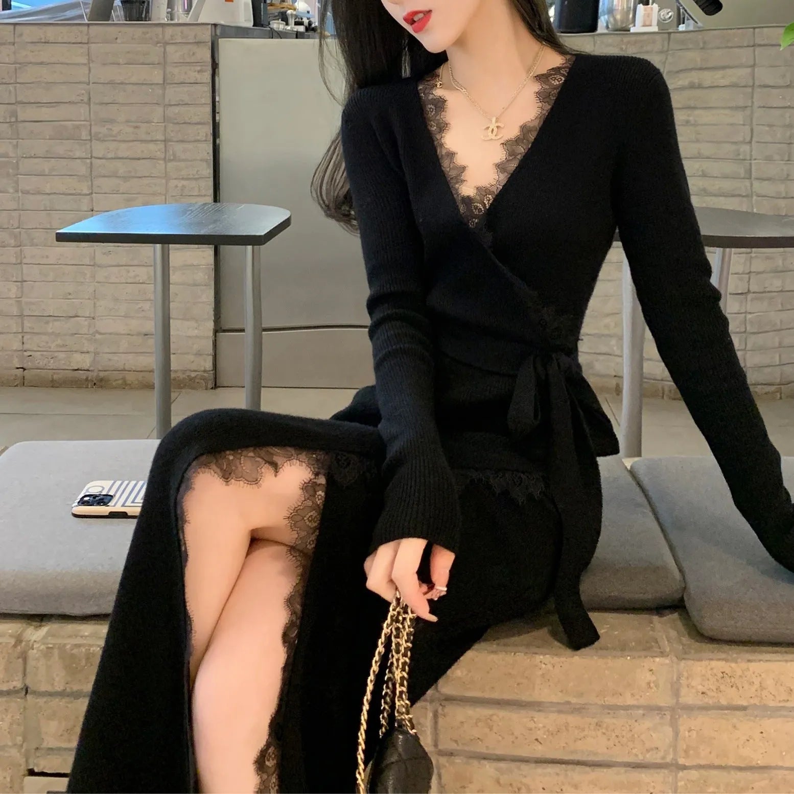 Black women's slim fit woolen skirt with a princess cut silhouette.
