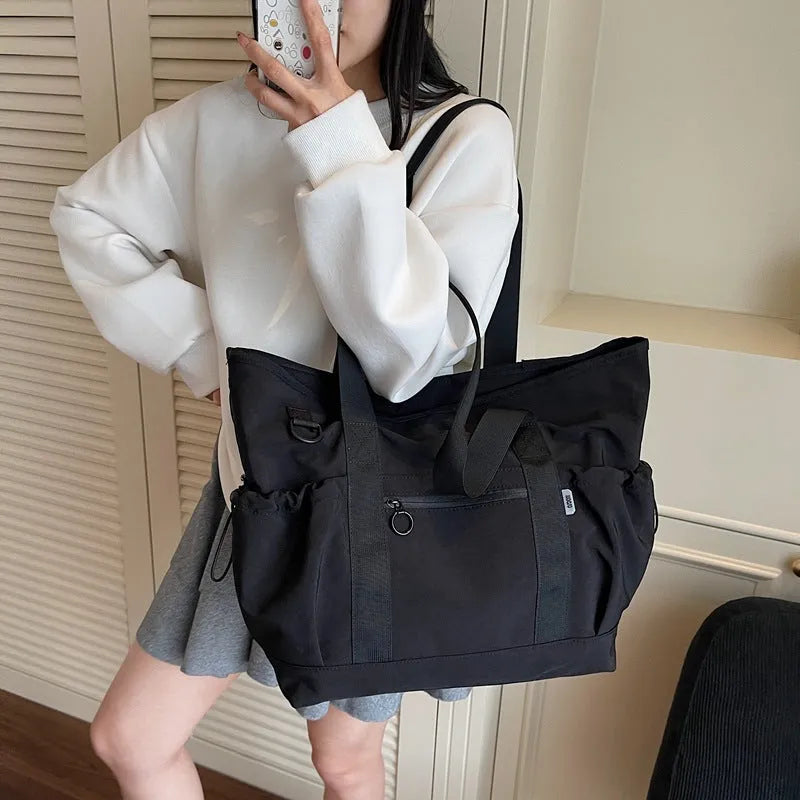Women's lightweight oxford cloth travel and gym bag in grey colour with letter pattern