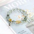 Green phantom quartz crystal bracelet with 8mm geometric beads showing gold rutile inclusions