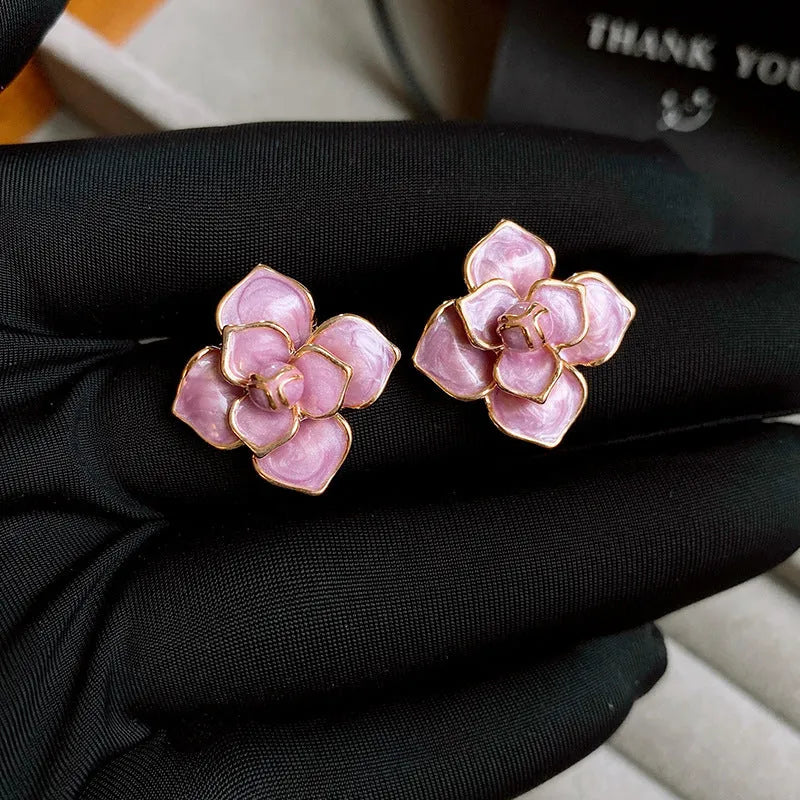 Gold plated purple flower stud earrings with copper base and fresh floral style on silver needle