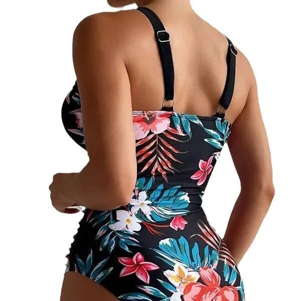 Women's floral one-piece swimsuit with backless design on a mannequin, showing high elasticity.