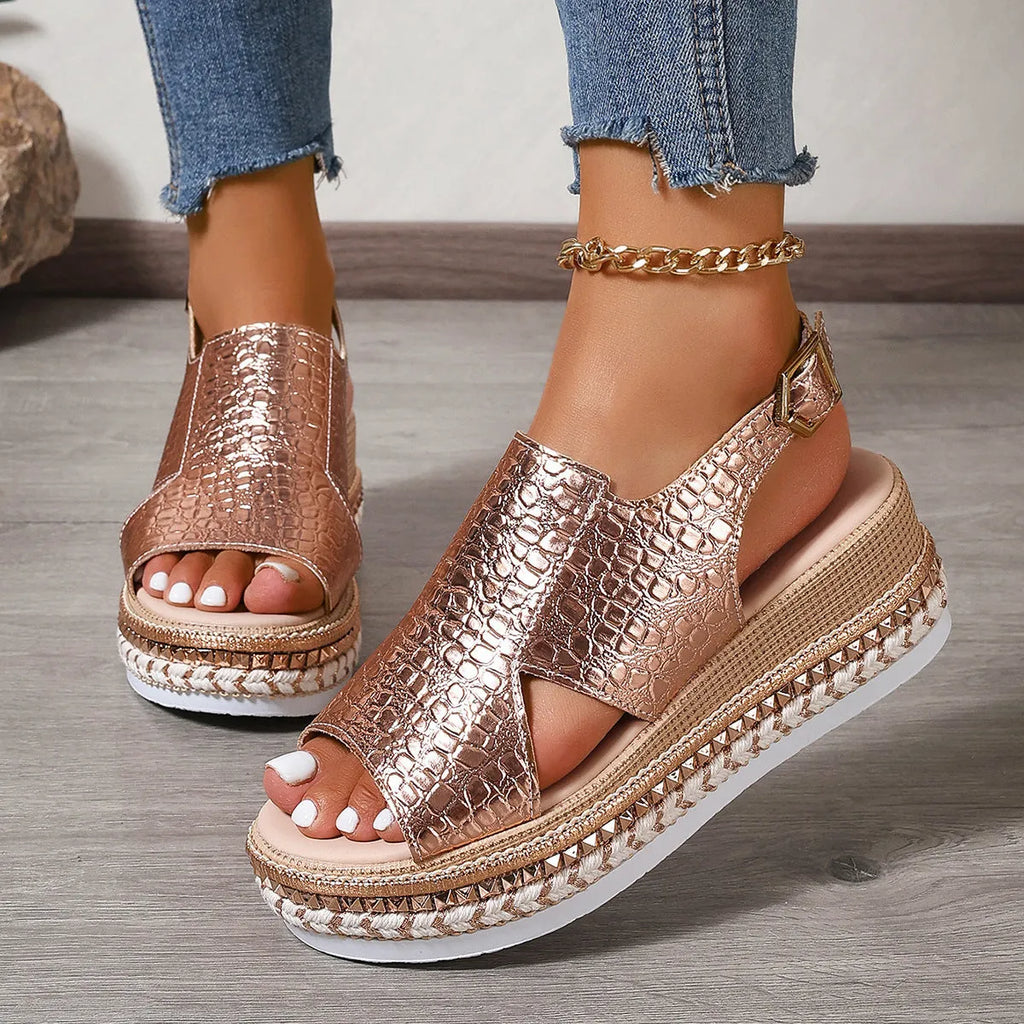 Gold women's Roman sandals with round toe, ankle buckle, and hollow-out design on a rubber sole.