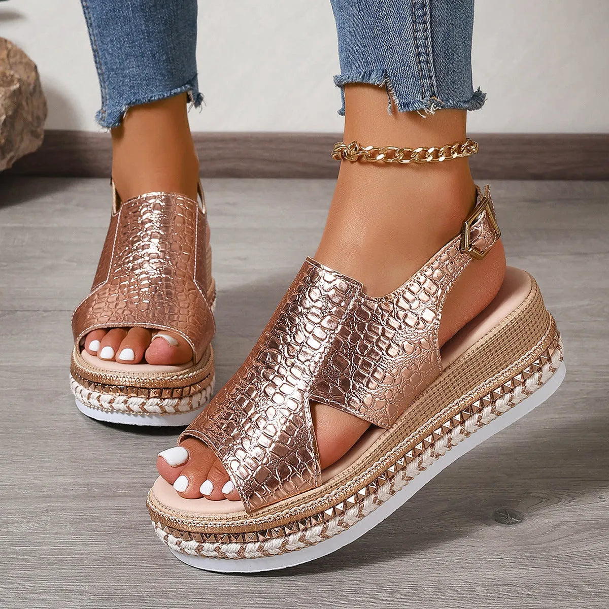 Gold women's Roman sandals with round toe, ankle buckle, and hollow-out design on a rubber sole.