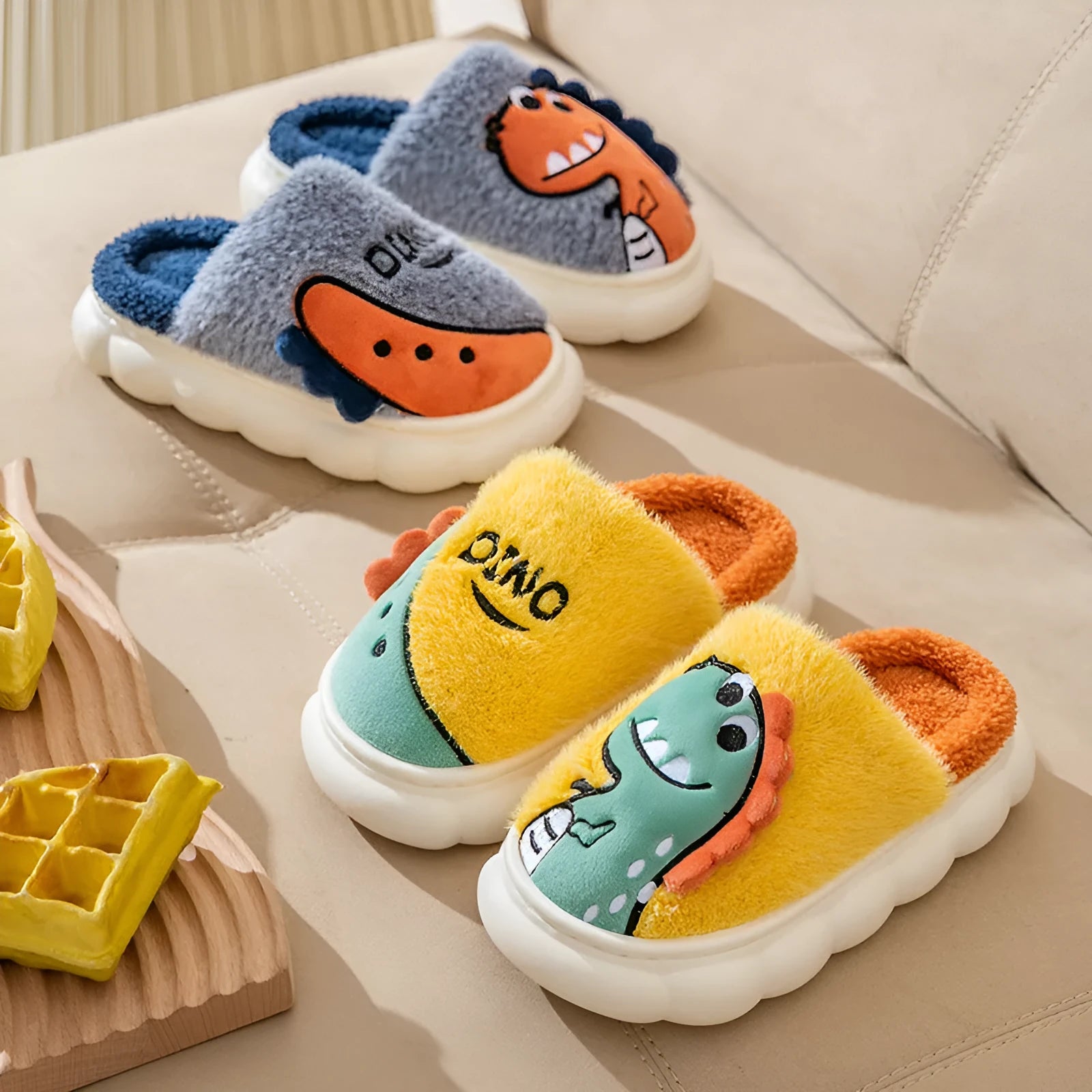 A pair of warm cotton plush dinosaur-themed indoor slippers for couples, shown in grey, coffee, and orange colour options.