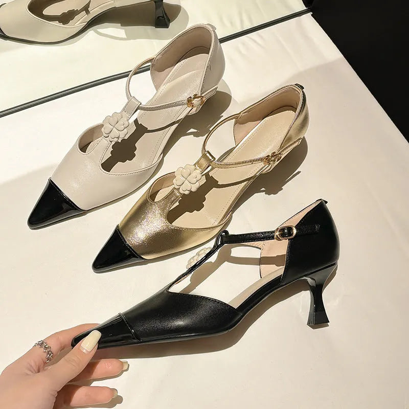 Women's gold stiletto heel with pointed toe, flower buckle, and shallow mouth cut on a sheepskin upper.