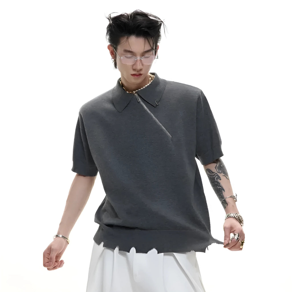 Man modelling a black slim-fit knitted polo shirt with a diagonal chest zipper and lapel collar.