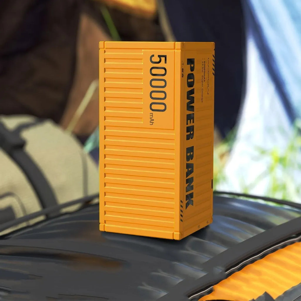Yellow, black, and silver 50000mAh power bank with digital display screen and multiple USB ports.