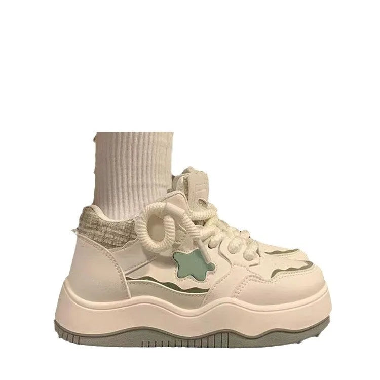 Women's green platform sneakers with lace-up front and round toe design on rubber sole
