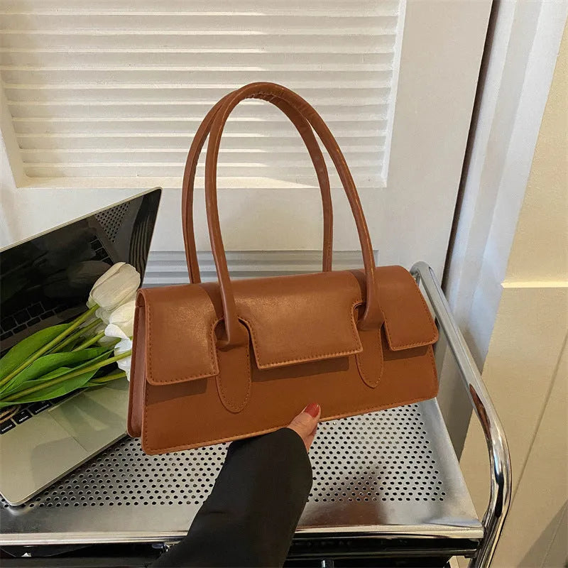 Women's small horizontal square shoulder bag in PU leather with single strap and stitching detail.
