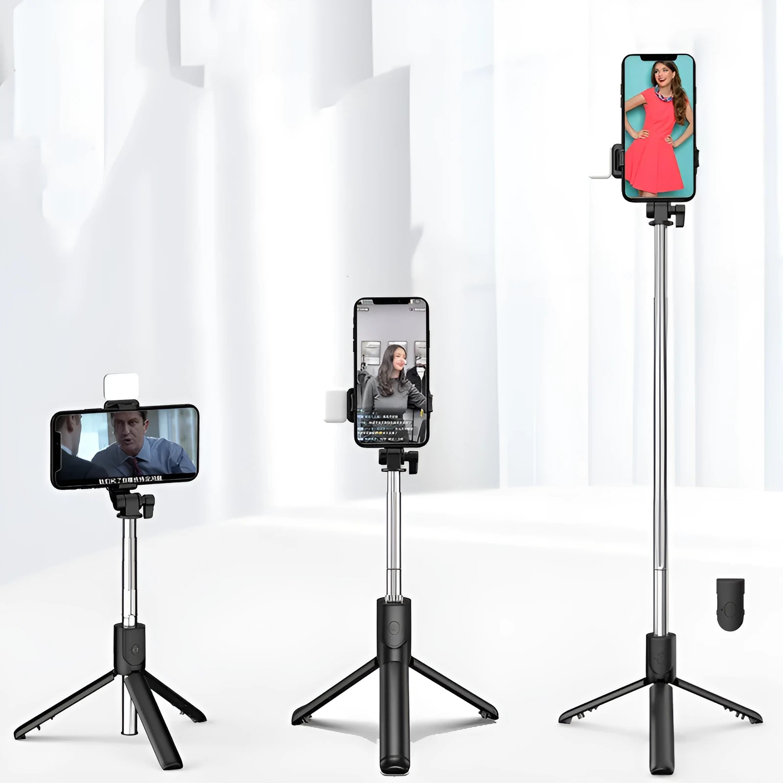 Black Bluetooth selfie stick with extended tripod legs holding a smartphone.