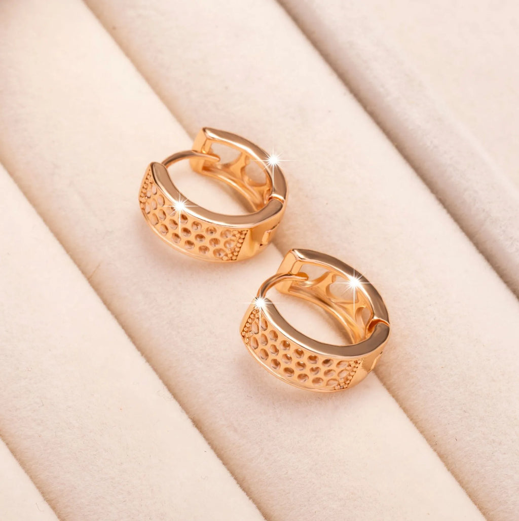 Rose gold women's earrings with three hollowed heart charms on a circular setting.