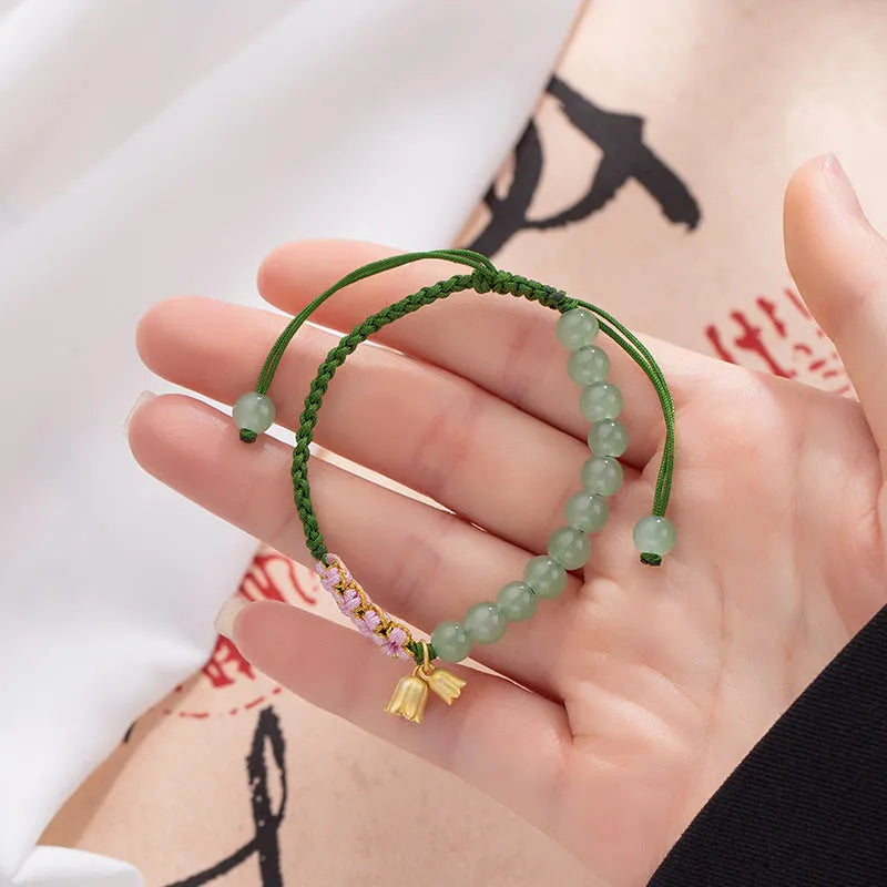 Red rope hand woven women's bracelet with floral decorative elements in BZ479 colour