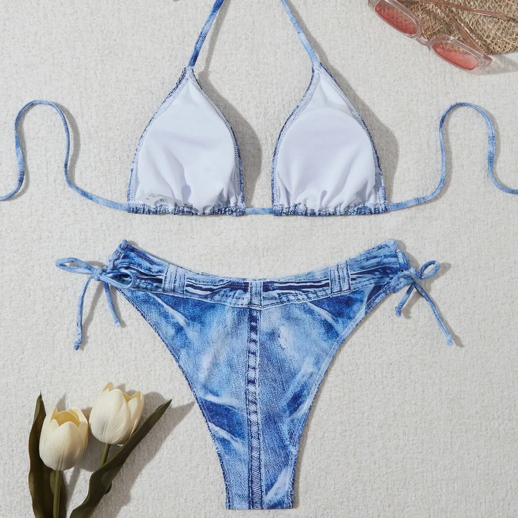 Denim blue printed women's bikini swimsuit with adjustable straps laid flat.