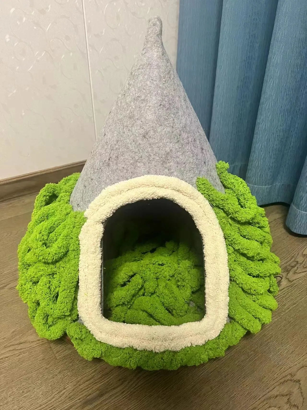 Grey cone-shaped felt cat house with tent-style enclosed design for indoor use