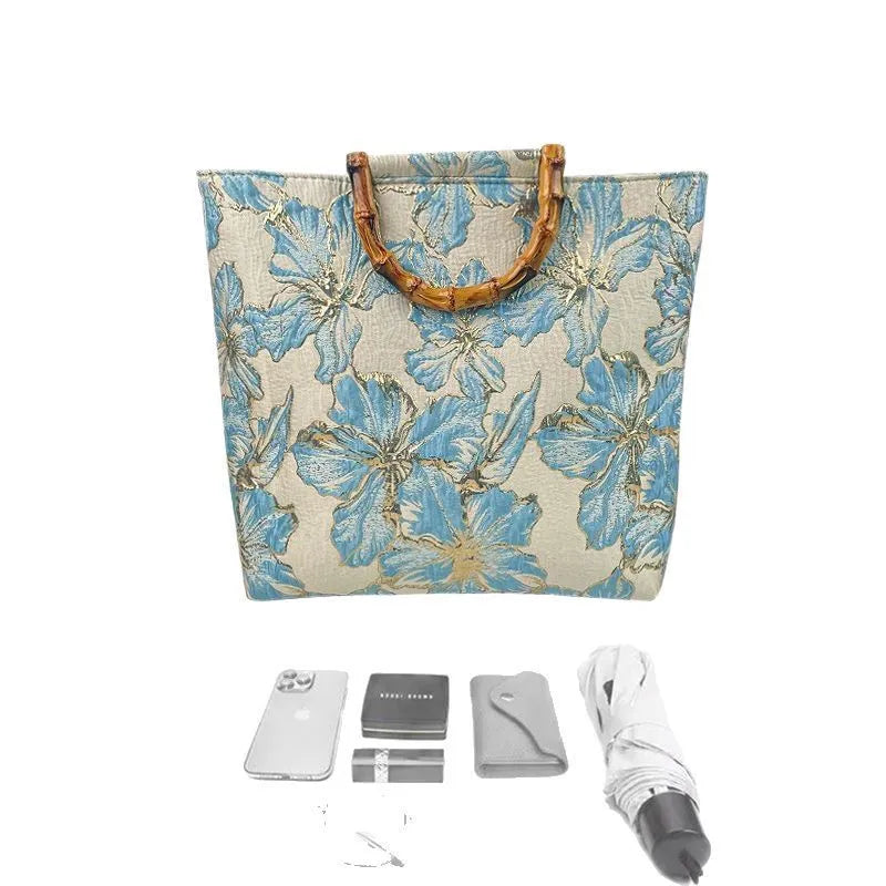 Light blue women's canvas shoulder bag with gold bronzing flower detailing showing horizontal square shape