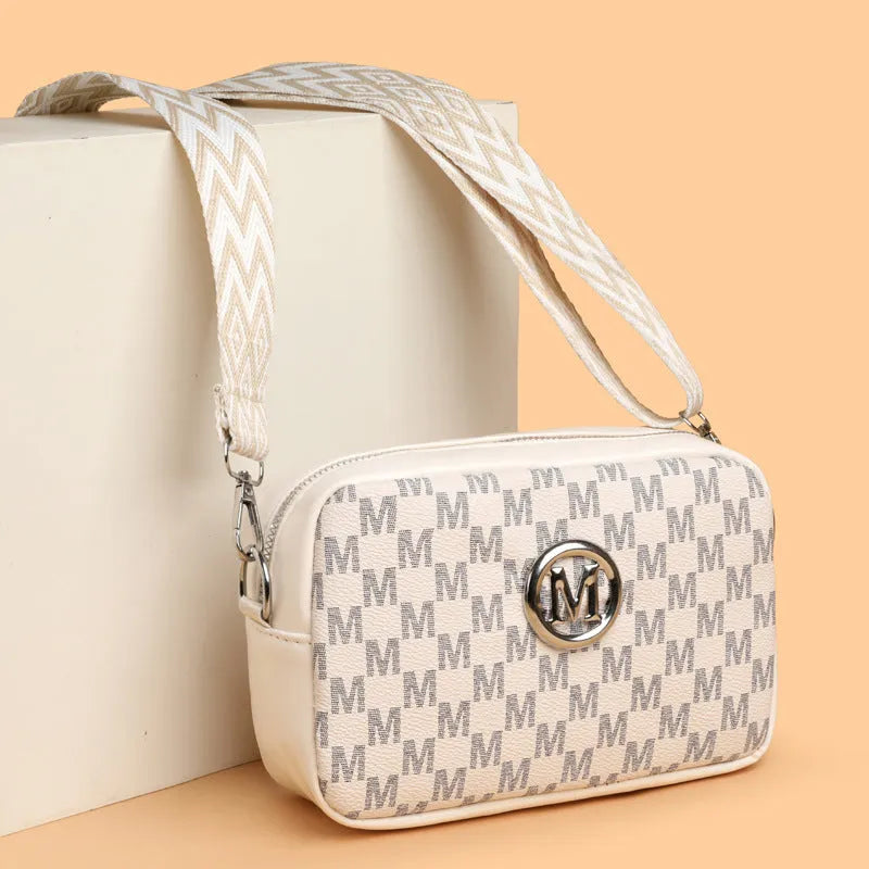 Crossbody bag with wide shoulder strap in black colour showing three-dimensional pocket construction