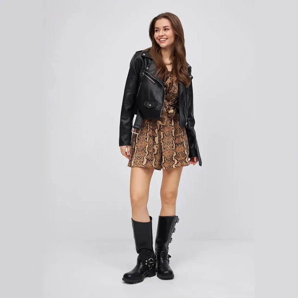 Women's black faux leather retro locomotive jacket with regular sleeves on a hanger.