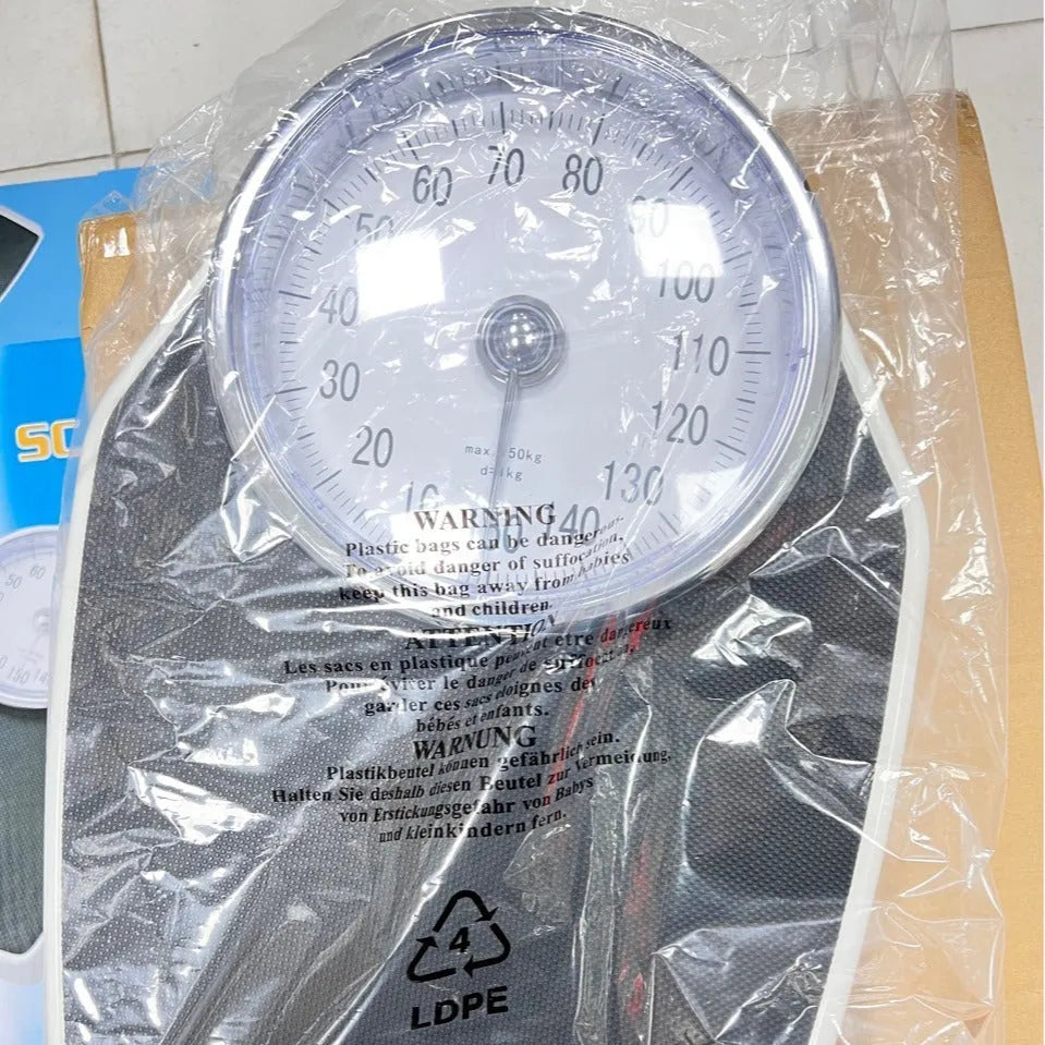 Black mechanical weight scale with large dial measuring 47x35x11cm