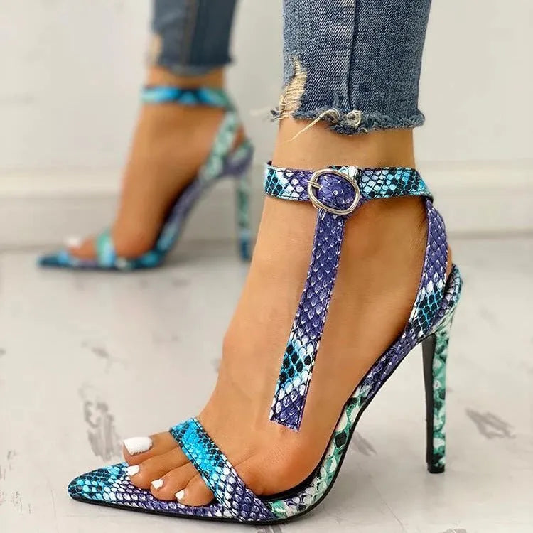 Blue women's high heels with buckle fastening and hollow out design on a pointed toe.