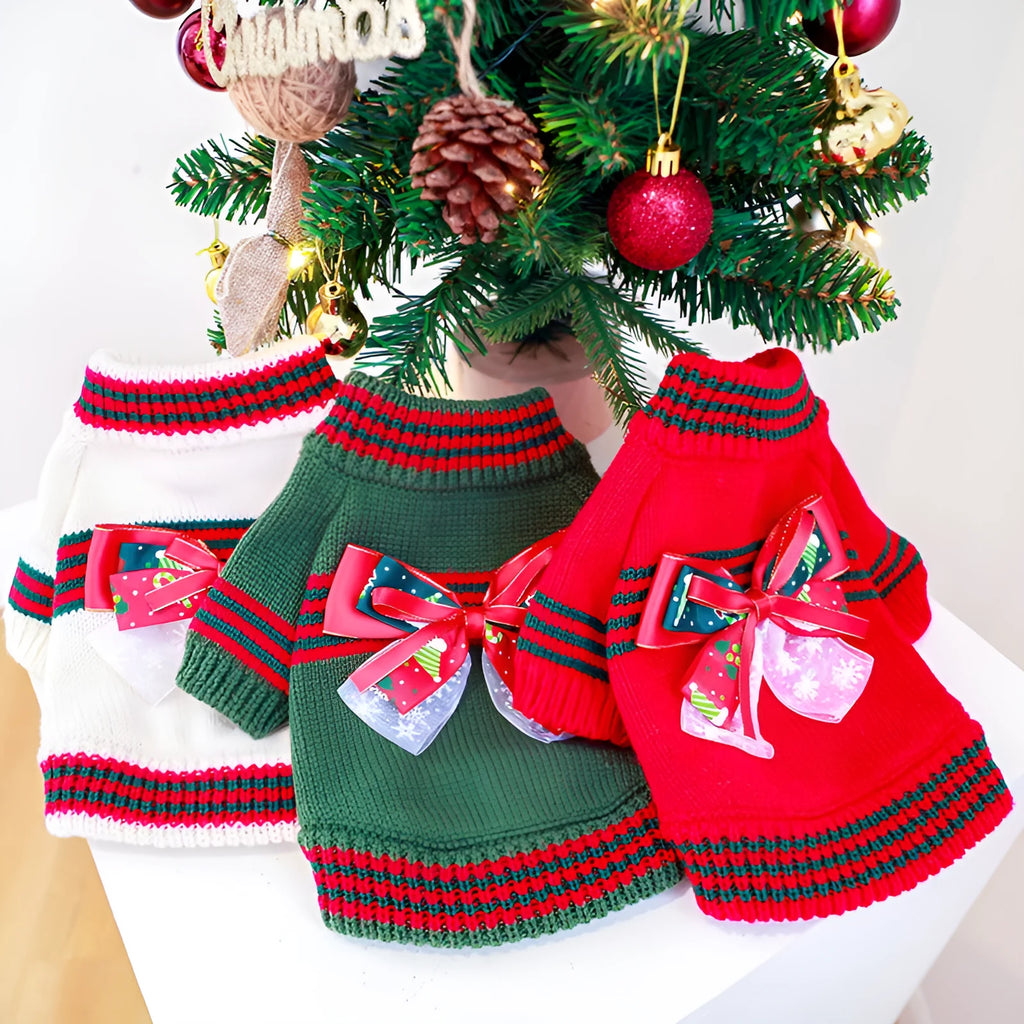 Red and green Christmas dog jumpers with festive print on a small dog model.
