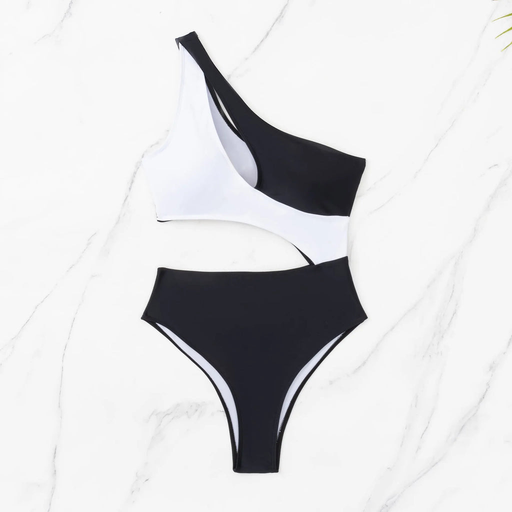 Black women's one-piece swimsuit with white contrast stitching and hollow cut-out design on a mannequin