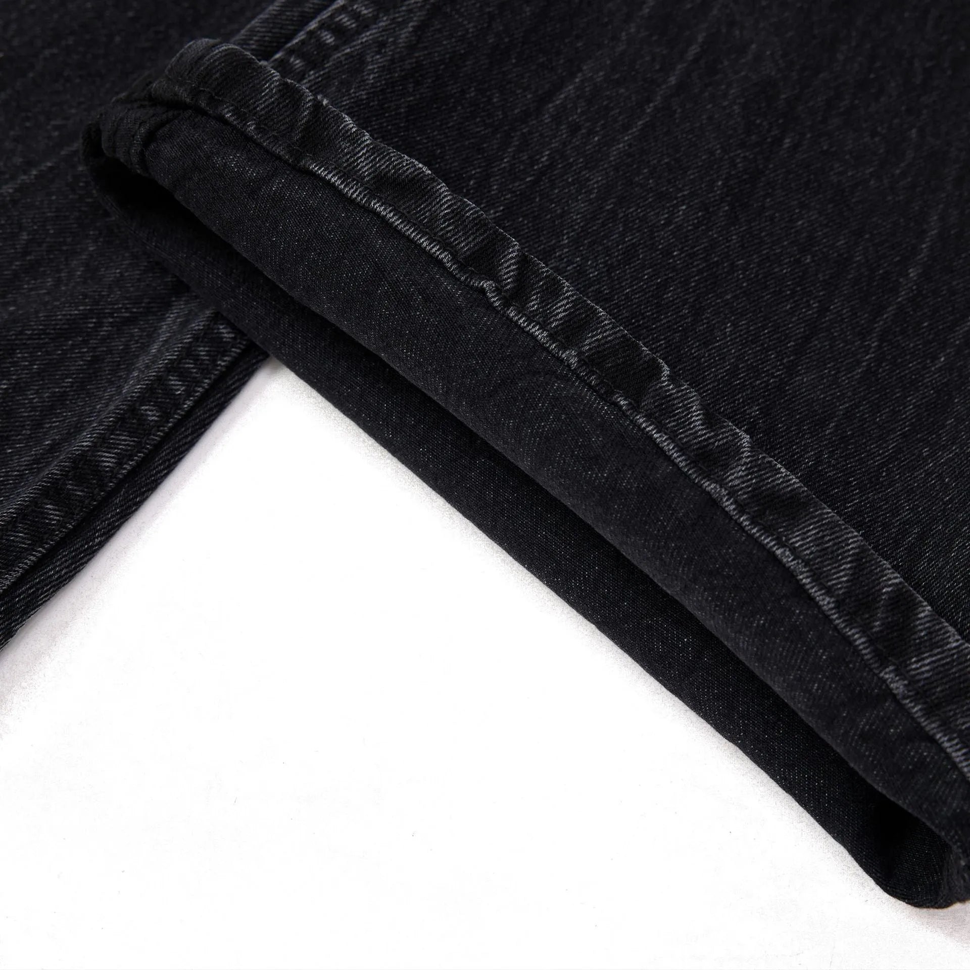 Black straight-leg men's jeans with a distressed lightning crack pattern on the legs.